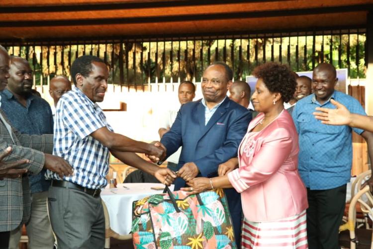Prof. Mbuthia and his wife  receiving a gift from the chairman Prof. Kamucha. 