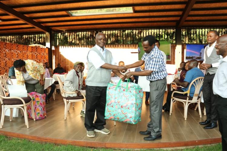 Prof. Gitari receiving a gift from the chairman Prof. Kamucha. 