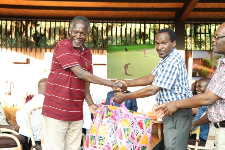 Mr. Ogaba receiving a gift from the chairman Prof. Kamucha. 