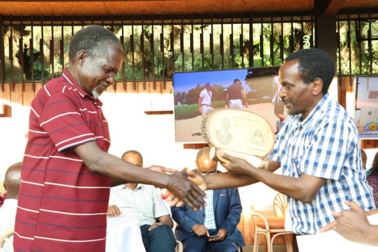 Mr. Ogaba receiving a plaque from the chairman Prof. Kamucha. 